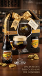 Geschenkset mit 4 Kasteel Bieren und einem Kasteel Bierglas in schwarzem Karton mit goldener Schleife.